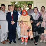 Vice Chancellor Women's University Prof. Dr. Kalsoom Paracha cutting ribbon to inaugurate stall of postage stamps in connection with World Post Day.