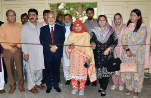  Vice Chancellor Women's University Prof. Dr. Kalsoom Paracha cutting ribbon to inaugurate stall of postage stamps in connection with World Post Day. 