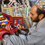 A painter busy in painting on model of truck at Dabgari area