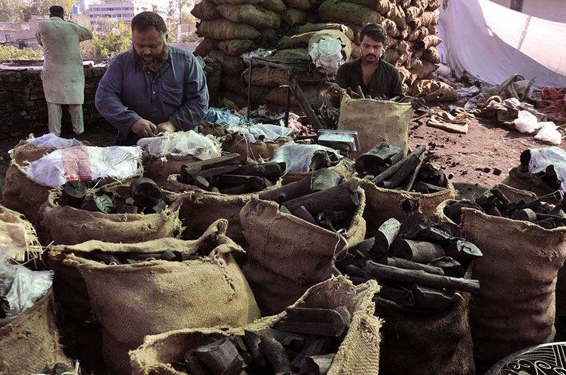 A vendor selling coal during the winter season at his setup