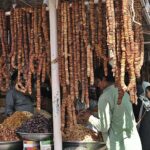 Vendors displaying dry fruits to attract the customers at weekly Sunday Bazaar, Peshawar Morr