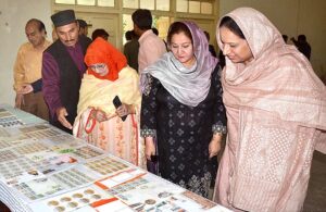 Vice Chancellor Women's University Prof. Dr. Kalsoom Paracha cutting ribbon to inaugurate stall of postage stamps in connection with World Post Day.