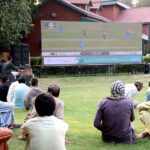 People watching World Cup cricket match playing between Pakistan and India teams on big screen installed at Boharan Wali Ground.