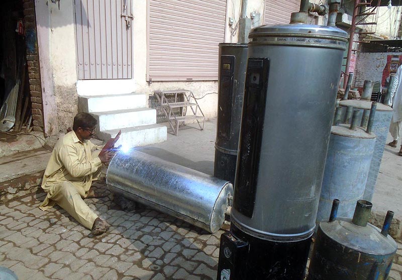 A worker busy in making gas geyser at railway road