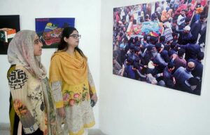 Visitors taking interest in photos during exhibition in connection with the Kashmir Solidarity Day at the Arts Council. 