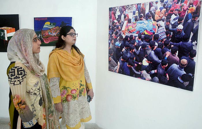 Visitors taking interest in photos during exhibition in connection with the Kashmir Solidarity Day at the Arts Council.
