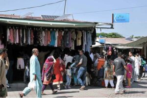 People busy in selecting and purchasing second hand shoes from vendors at weekly Sunday Bazaar, Peshawar Morr