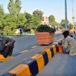 Labourers busy in paint the center path of road