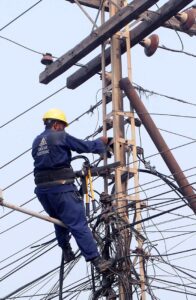 MEPCO staffer busy in installation work of electric cable at Katchery Road.