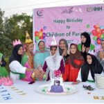 Principal of Khubaibe Girls School, Sarwat Ansar and members of Turkish NGO (iHH) Insani Yardim Vakfi delegation cutting birthday cake of orphan girls during visit Khubaibe Girls School and College celebrating orphans solidarity day
