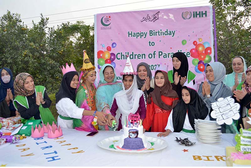 Principal of Khubaibe Girls School, Sarwat Ansar and members of Turkish NGO (iHH) Insani Yardim Vakfi delegation cutting birthday cake of orphan girls during visit Khubaibe Girls School and College celebrating orphans solidarity day