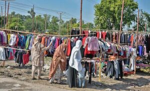 Women selecting and purchasing old clothes from setup along Islamabad Expressway