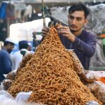 Vendor selling and displaying traditional sweet item to attract the customers at Rampura Gate.