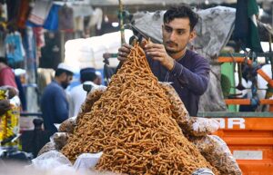 Vendor selling and displaying traditional sweet item to attract the customers at Rampura Gate.