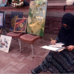Student giving final touch to her painting during Painting and Calligraphy Exhibition organized by Formanite School System at Wazir Khan square inside Delhi gate