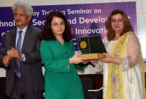 DG IPO Shazia Adnan giving shield to participant during training workshop. 