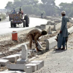 Labourers are busy in fixing the cemented block for the diversion of the newly constructed head Muhammad Wala road.