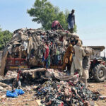 Labourer loading valuables on tractor trolley after collecting from garbage at Tando Yosuf Road.