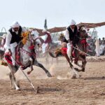 Horse riders participating in tent pegging during a tent pegging competition held at Mela Qureshia Chak no 163 NB