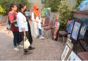 Student giving final touch to her painting during Painting and Calligraphy Exhibition organized by Formanite School System at Wazir Khan square inside Delhi gate
