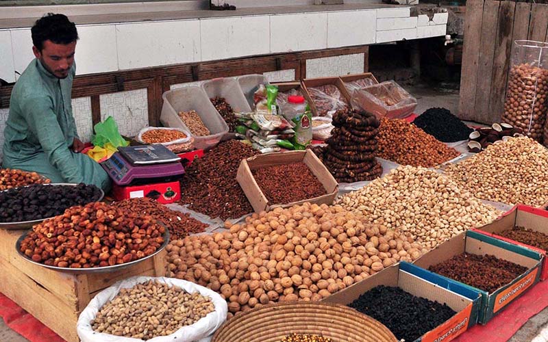 A vendor selling dry fruit on his roadside setup