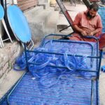 A man is busy knitting traditional bed (charpai) in his work place at lakshmi chowk