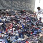 A man is looking to buy ties at road side setup in the city