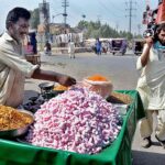 Vendor displaying sweet and salty items to attract customers at roadside.
