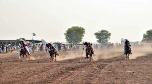 Horse rider participating in tent pegging during a tent pegging competition held at Mela Qureshia Chak no 163 NB.