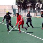 Women hockey players in action during Education Department South Punjab Inter District sports hockey tournament