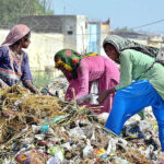 Gypsy women searching the valuables items from garbage at Latifabad.