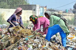 Gypsy women searching the valuables items from garbage at Latifabad. 