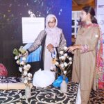 Female visitor watching cotton plants during the ceremony of World Cotton Day