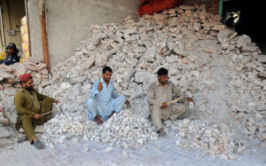 Labourers busy in crushing salt into tiny pieces at their workplace.