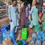 People busy in filling their cans with clean water from tap at Latifabad