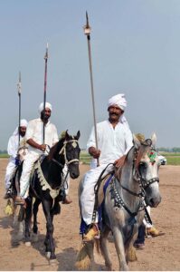 Horse rider participating in tent pegging during a tent pegging competition held at Mela Qureshia Chak no 163 NB.
