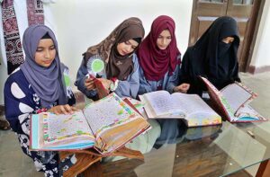  Students viewing the calligraphy work of Quranic verses during Exhibition of calligraphy at Government Collage University. 