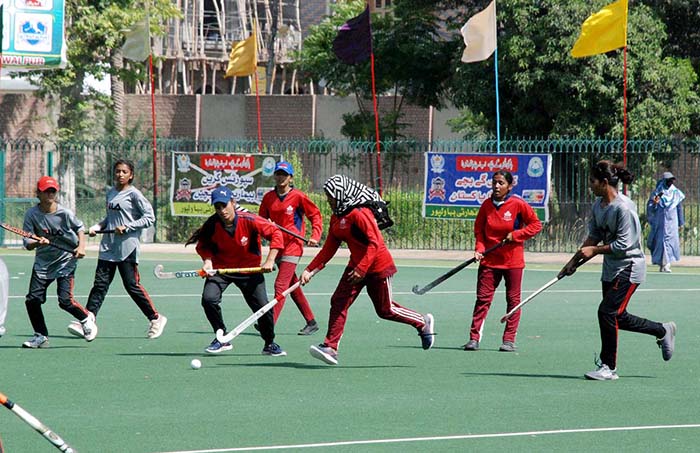 Female hockey players in action during South Punjab Inter District sports hockey tournament.