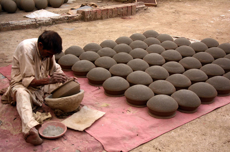 A craftsman preparing clay-made pots at his workplace