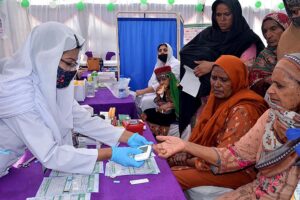 Lady Doctor examine a child in a medical camp during Health Week at THQ Hospital Chak no 90 SB