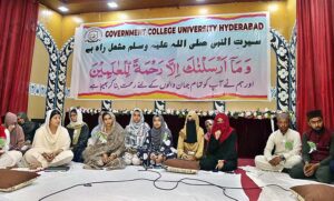 Students viewing the calligraphy work of Quranic verses during Exhibition of calligraphy at Government Collage University.