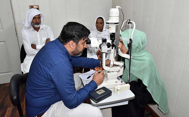 A doctor examining and eye patient during Sharifan Babi Free Medical Camp organizer Shade Trust