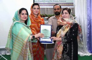 Program officer SPO Mr. Fazli Ghafoor giving shield to Deputy Registrar Affiliation & Monitoring Section Ms Tashfeen Zia during the celebration of International Day of Natural Disaster Reduction at GFC