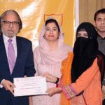 Federal Secretary Ministry of Education & Professional Training Waseem Ajmal Chaudhary is distributing certificates among the students of National Textile University Faisalabad (NTUF) during scholarship distribution ceremony under National Endowment Scholarships for talent holders