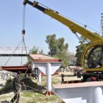 A view of Construction work of newly install overhead bridge at Captain Karnal Sher Khan Shaheed Avenue.