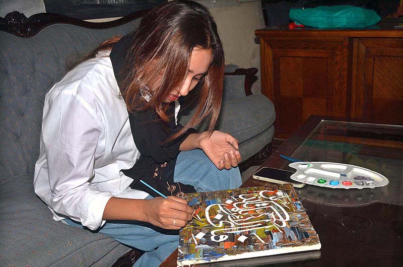 Student giving final touch to her painting in Last day calligraphy workshop at Bab-e-Pakistan and information Culture Punjab