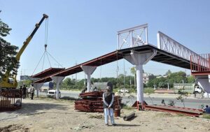 A view of Construction work of newly install overhead bridge at Captain Karnal Sher Khan Shaheed Avenue.