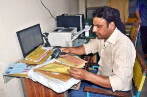 Postman busy in his work on the occasion of World Post Day at the GPO.