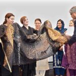 IAC Chancellor Muhammad Faisal Janjua presents a shawl to the Prime Minister's Special Assistant on Human Rights Ms. Mashaal Hussain Malik on the occasion of a seminar on women's empowerment at the Institute of Art and Culture