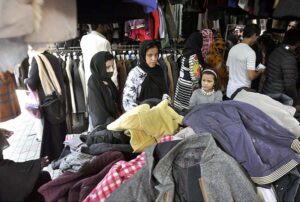 People purchasing clothes from a vendor at H9 Bazar in the Federal Capital